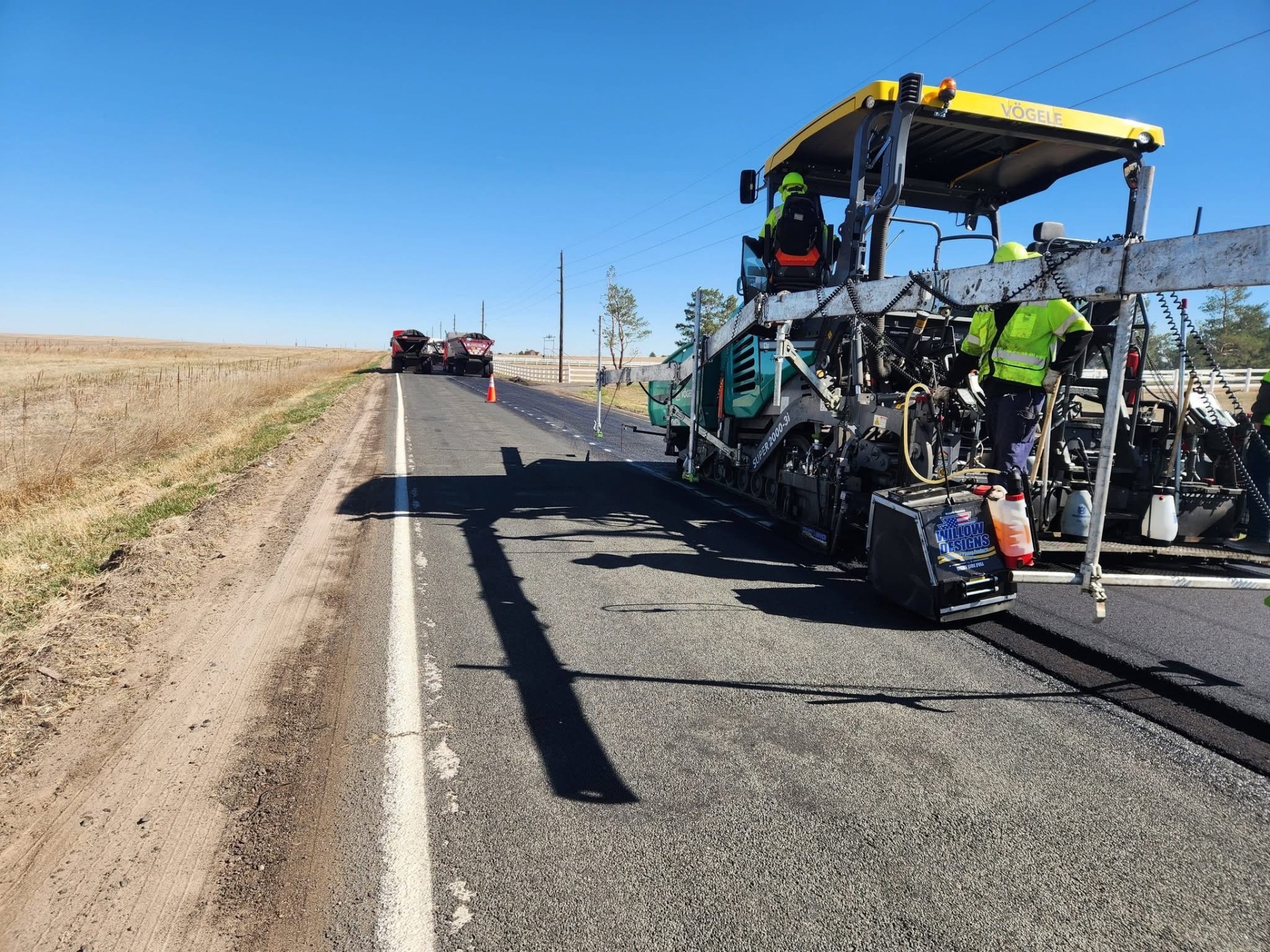 Luxury Denver home with freshly paved asphalt driveway against the Rocky Mountains